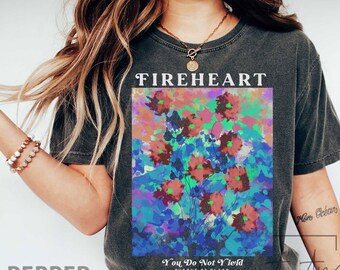 May include: A charcoal grey t-shirt with a graphic print of colorful flowers and the text "FIREHEART" and "You Do Not Yield, Throne of Glass".