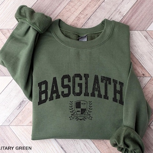May include: A military green sweatshirt with the text "BASGIATH" in black, with a crest and the text "Swan College" underneath.