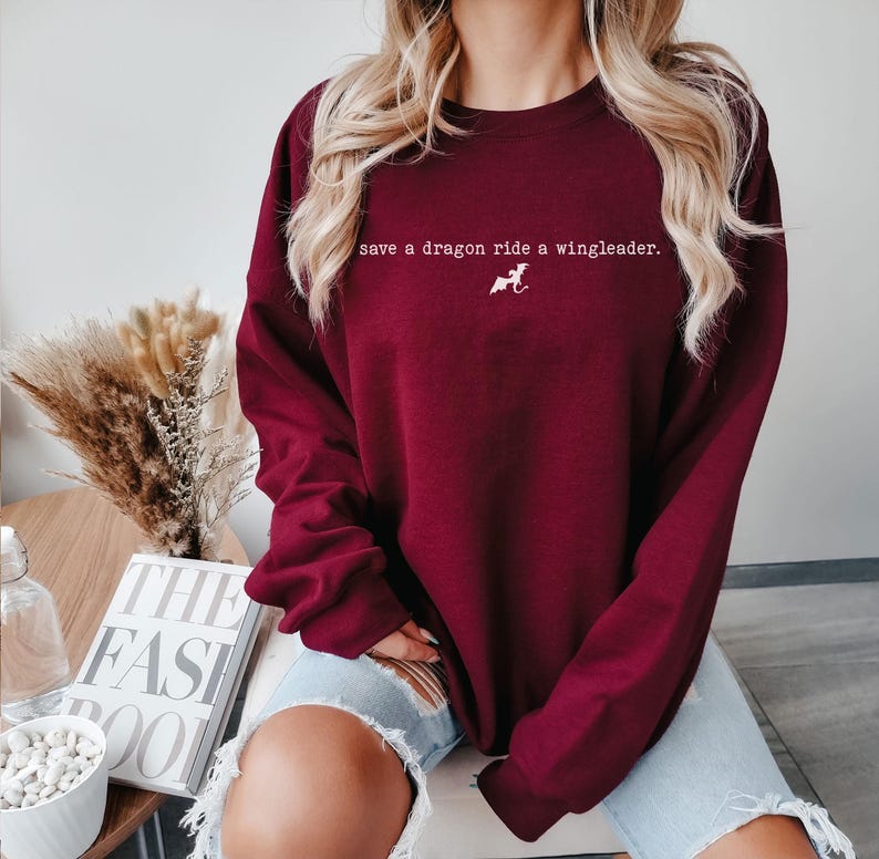 May include: A maroon sweatshirt with the text "save a dragon ride a wingleader." printed in white on the front.