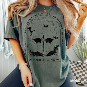 May include: A dark green t-shirt with a black graphic print of a dragon and the text "A rider without its dragon is a tragedy. A rider without their dragon is dead. Fourth Wing."