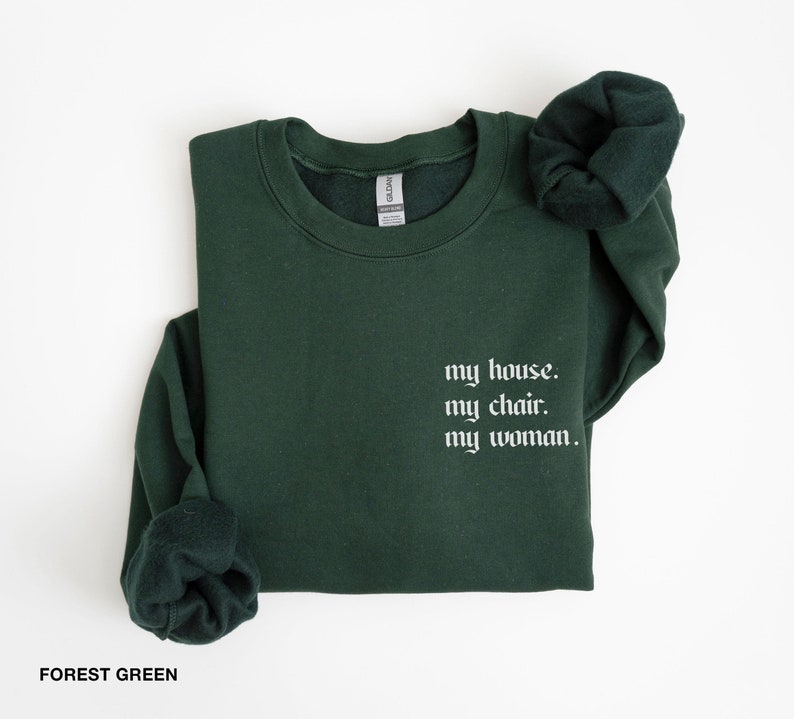 May include: Forest green sweatshirt with the text "my house. my chair. my woman." in white.