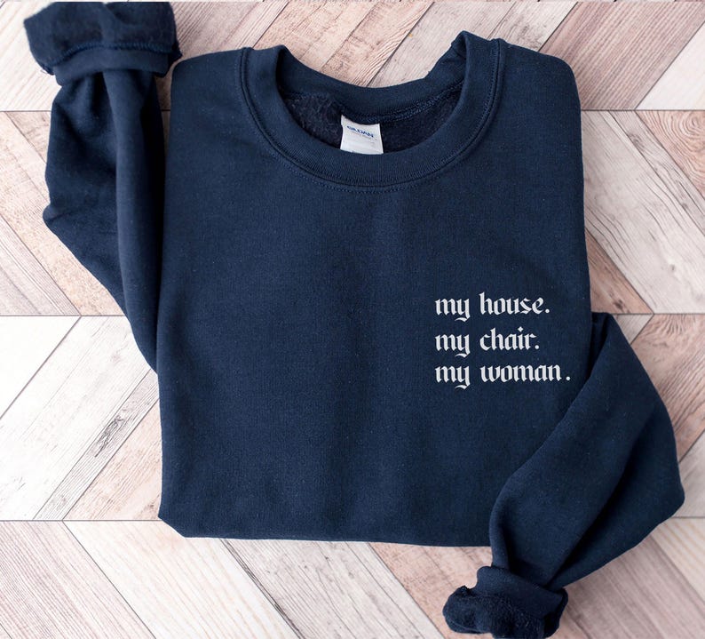 May include: A dark blue sweatshirt with the text "my house. my chair. my woman." printed in white on the front.