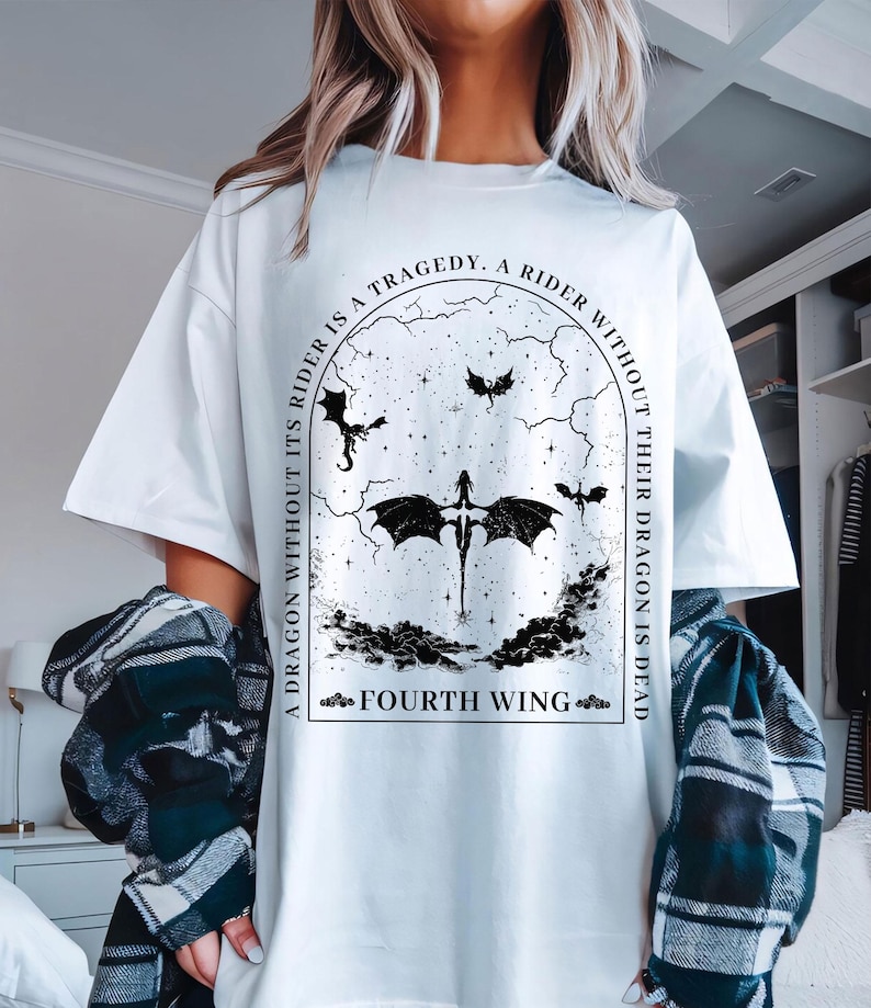 May include: White t-shirt with a black graphic print of a dragon with the text "A dragon without its rider is a tragedy. A rider without their dragon is dead. Fourth Wing."