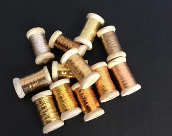 Japanese Flat Thread Collection. 12 x 12 metres(144 metres total)different shades on wooden bobbins in a gift box.