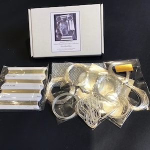 May include: A set of Japanese silk and metal thread embroidery supplies in clear plastic bags. The set includes a variety of silver threads, a mesh fabric, and a card with the text "Japanese Silk and Metal Thread Embroidery Collection Arababashi".