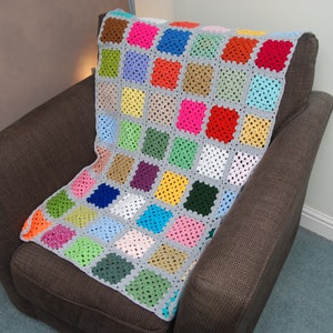 Hand made small Crochet Blanket / Chair cover with squares in individual colours with silver grey border.
