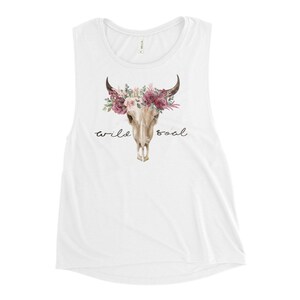 May include: White muscle tank top with a floral skull graphic and the text "wild soul".