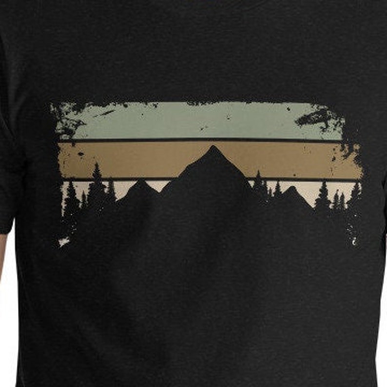 May include: A black t-shirt featuring a vintage-style graphic of a mountain range with trees in front of a faded horizontal stripe design.