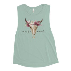 May include: A light blue sleeveless muscle tank top with a floral skull design and the text "wild soul".