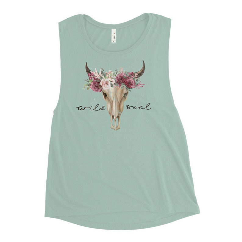 May include: A light blue sleeveless muscle tank top with a floral skull design and the text "wild soul".
