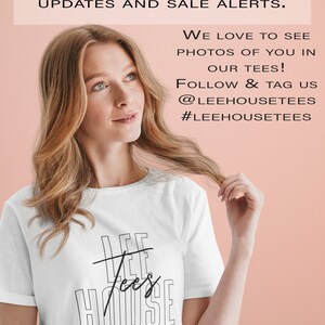 May include: White t-shirt with black text that reads "LEE Tees HOUSE". A woman is wearing the shirt and is looking off to the side. The background is a light pink color.
