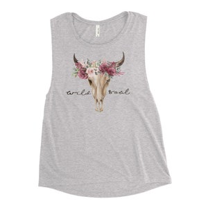 May include: A gray muscle tank top with a floral skull design and the text "wild soul".