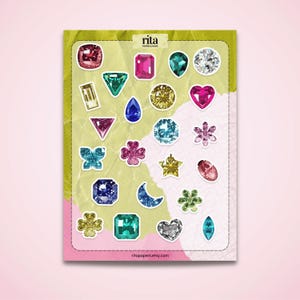 May include: A sheet of gem stickers in various shapes and colors, including pink, blue, green, and gold. The stickers are arranged on a green and pink background. The text "rita papers & more" and "ritapapers.etsy.com" are visible.