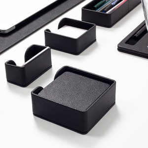 May include: Black leather desk organizer set with compartments for pens, pencils, business cards, and notepads.