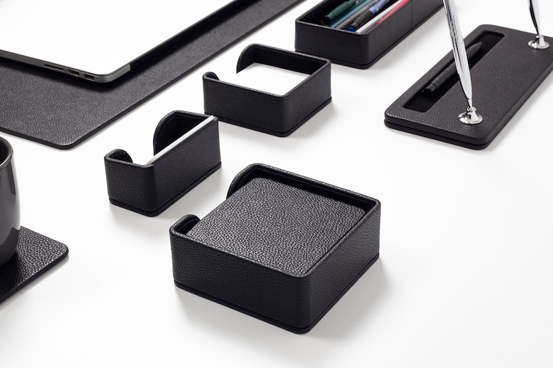 May include: Black leather desk organizer set with compartments for pens, pencils, business cards, and notepads.