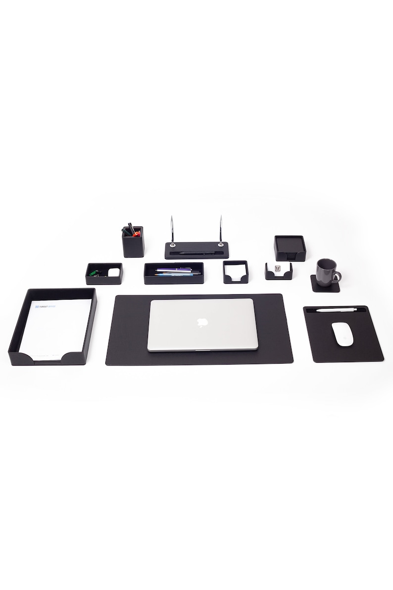 May include: A black desk organizer set with a laptop, a pen holder, a tray for pens, a note holder, a business card holder, a letter tray, a mouse pad, and a cup holder.