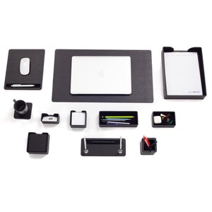 May include: A black desk organizer set with a laptop, a mouse, a pen holder, a pencil holder, a tray, and a notepad. The set is on a white background.