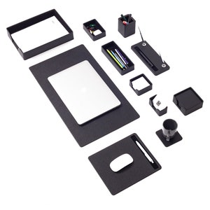 May include: Black desk organizer set with a laptop, mouse pad, pen holder, and other office supplies.