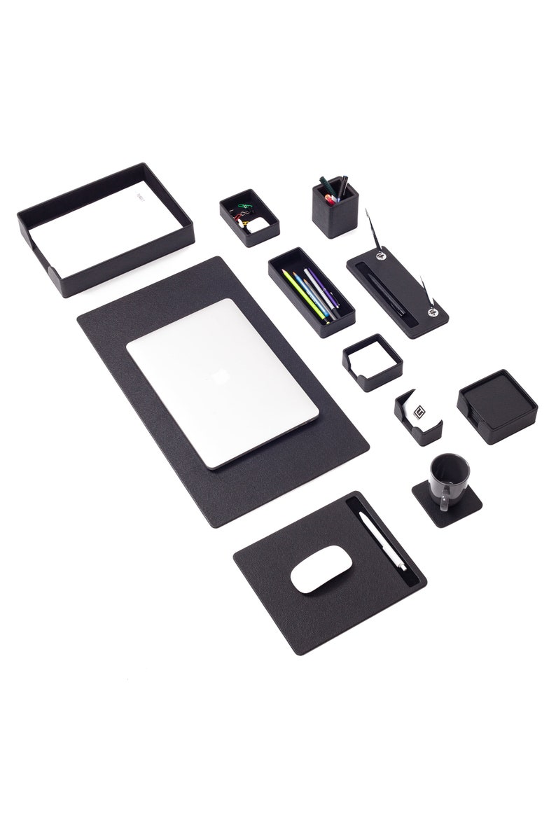 May include: Black desk organizer set with a laptop, mouse pad, pen holder, and other office supplies.