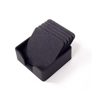 May include: A set of six black leather coasters in a matching black leather holder.