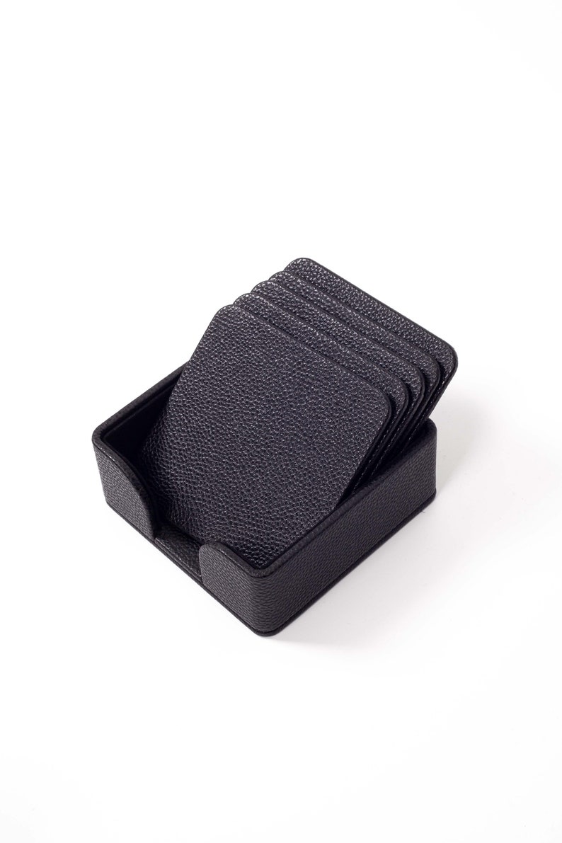 May include: A set of six black leather coasters in a matching black leather holder.