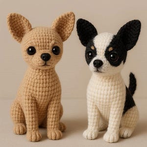 May include: Two crocheted Chihuahua dog figurines. One is tan, the other is white with black markings. Both have large, dark eyes and pointed ears. They are sitting upright, showcasing their detailed craftsmanship.
