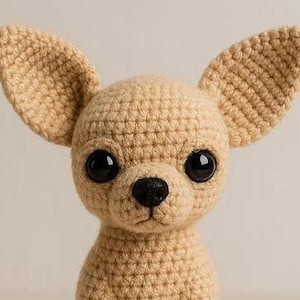 May include: A crocheted chihuahua dog with large, black eyes and a black nose. The dog has large, upright ears and is made of tan yarn. The handmade dog is a cute, soft toy.