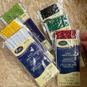 May include: Assortment of colorful baby rick rack trim in green, yellow, white, black, green, and red. Each package is labeled with the brand "Wrights" and includes measurements of 4 yards and .25 inches wide.