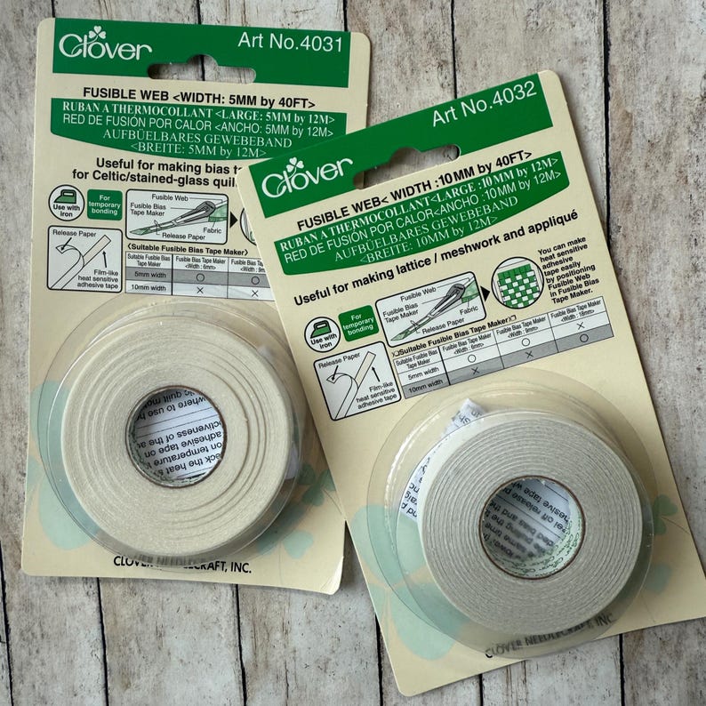May include: Two packages of Clover fusible web tape for fabric crafts. One package is 5mm wide, the other is 10mm wide. The packaging includes instructions for use and the Clover logo.