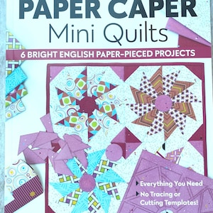 May include: A book titled "PAPER CAPER Mini Quilts" with the subtitle "6 Bright English Paper-Pieced Projects." The cover features colorful quilt block designs and the text "Everything You Need, No Tracing or Cutting Templates!" by Sue Daley.