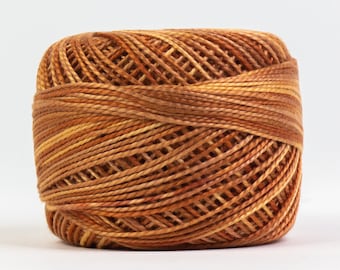 May include: A ball of brown and orange embroidery floss.