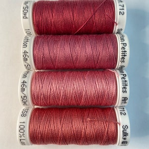 May include: Four spools of Sulky cotton thread in the color Art. 712, a deep rose pink. Each spool is labeled with the brand name, color number, and length of thread.