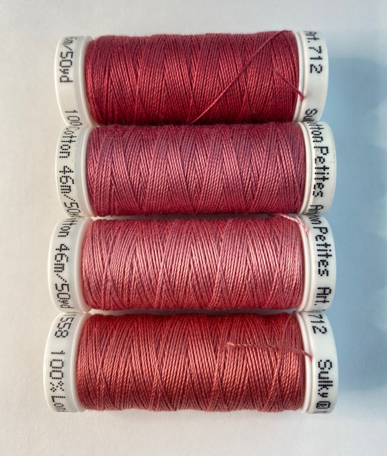 May include: Four spools of Sulky cotton thread in the color Art. 712, a deep rose pink. Each spool is labeled with the brand name, color number, and length of thread.
