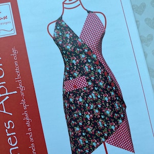May include: A printed apron pattern featuring a halter top design with a split-angled bottom edge. The apron has a black floral print, red gingham check, and red accents. The text "Corners Apr" and "P233" are visible.
