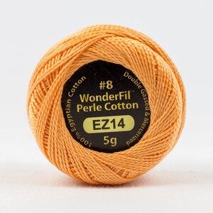 May include: A 5 gram spool of orange #8 WonderFil Perle Cotton thread. The label reads "100% Egyptian Cotton, Double Gassed & Mercerized, EZ14".