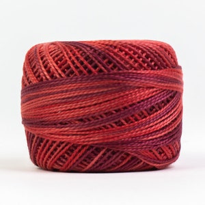 May include: A spool of red and burgundy embroidery floss with a gradient effect.