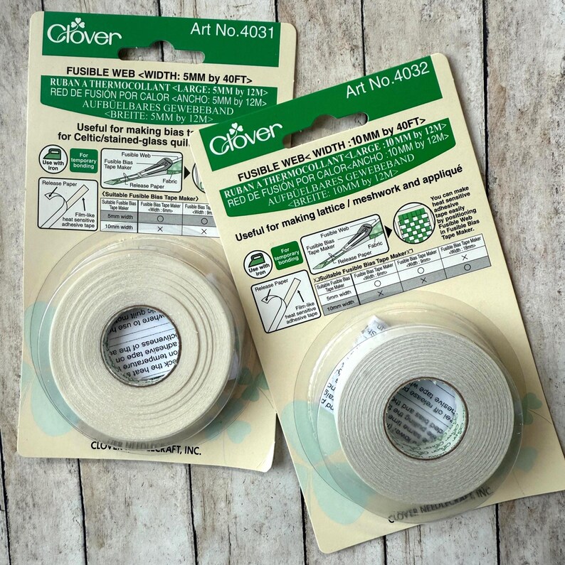 May include: Two packages of Clover fusible web tape for fabric crafts. One package is 5mm wide, the other is 10mm wide. The packaging includes instructions and diagrams for use. The tape is useful for making bias tape and lattice/meshwork.