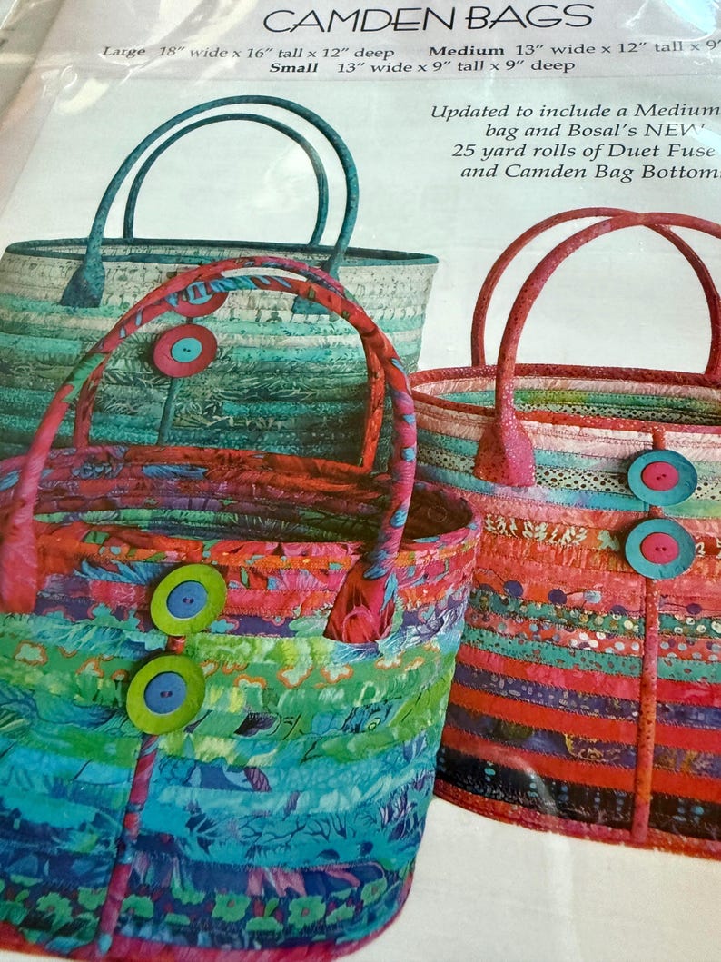 May include: A sewing pattern for Camden Bags featuring three tote bags made from colorful fabric strips. The bags are decorated with large buttons. The text includes dimensions for large, medium, and small bags, and mentions Bosal's Duet Fuse.