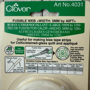 May include: A package of Clover fusible web for making bias tape strips. The package is green and white, with text indicating a 5mm width and 40ft length. Instructions and diagrams are included for use with an iron and fabric.