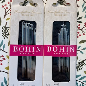 May include: Two packages of Bohin straw millinery needles. The packages are white with gold lettering and feature the text "Manufacture Française" and "Depuis 1833". The packages are labeled "1" and "3/9" and both say "Mode Straw - Milliners".