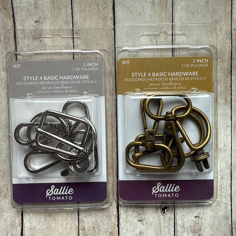 May include: Two clear plastic blister packs containing Style 4 Basic Hardware purse hardware kits. One pack features silver-toned metal clips and rings, while the other contains antique brass-toned metal clips and rings, both labelled 1 inch.