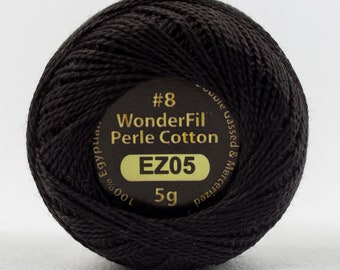 May include: A black WonderFil Perle Cotton thread ball. The label reads "#8 WonderFil Perle Cotton EZ05 5g". The thread is tightly wound, and the label is a dark brown with gold lettering and a green accent.