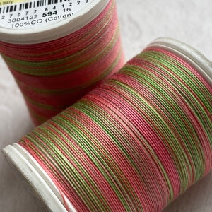 May include: Two spools of pink and green cotton thread. The spools are labeled "Cotton Blendables 30 wt. col 4122 733-4122 500yds 450m 3004122 594 100%CO (Cotton)"