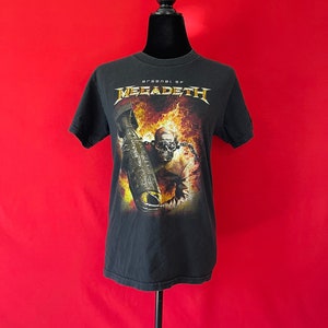 May include: Black t-shirt with a graphic of a skull holding a bomb in flames. The text "Arsenal of Megadeth" is printed above the graphic.