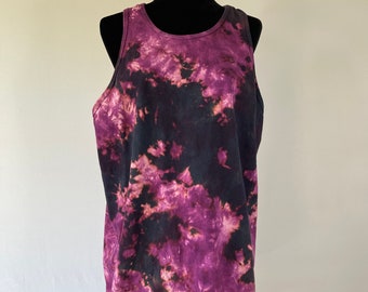 May include: A purple and black tie-dye tank top. The tank top has a relaxed fit and a scoop neck.