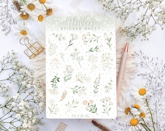 Pode incluir: Uma folha de adesivos com fundo branco e borda verde. A folha apresenta uma variedade de flores brancas e folhas verdes. O texto "Flowers Sticker Sheet" está impresso em preto no topo da folha. O texto "Out of the Box" está impresso em preto na parte inferior da folha.