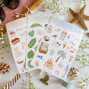 May include: Three sticker sheets with summer themes. The sheets are white with colorful illustrations of tropical leaves, beach scenes, and summer activities. The text on the sheets reads "Summer Sticker Sheet", "Tropical Leaves Sticker Sheet", and "Beach Sticker Sheet".