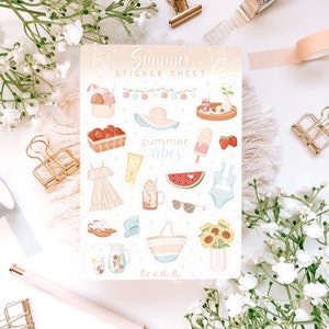 May include: A sticker sheet with a summer theme. The sheet features illustrations of a watermelon, ice cream, sunglasses, a swimsuit, a beach bag, a dress, a pitcher of lemonade, and a basket of strawberries. The text "Summer Vibes" is featured on the sheet.