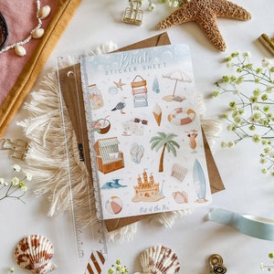 May include: A sticker sheet with a beach theme. The sheet features a variety of stickers, including a beach umbrella, a beach chair, a surfboard, a palm tree, a sandcastle, a seashell, a starfish, a coconut, a drink, and a pair of sunglasses. The sheet is titled "Beach Sticker Sheet" and has the text "Out of the Pin" at the bottom.