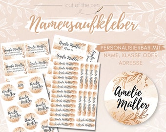 May include: A set of personalised name stickers with a watercolour background and gold leaf accents. The stickers feature the name "Amelie Muller" and can be customised with a name, class, or address.
